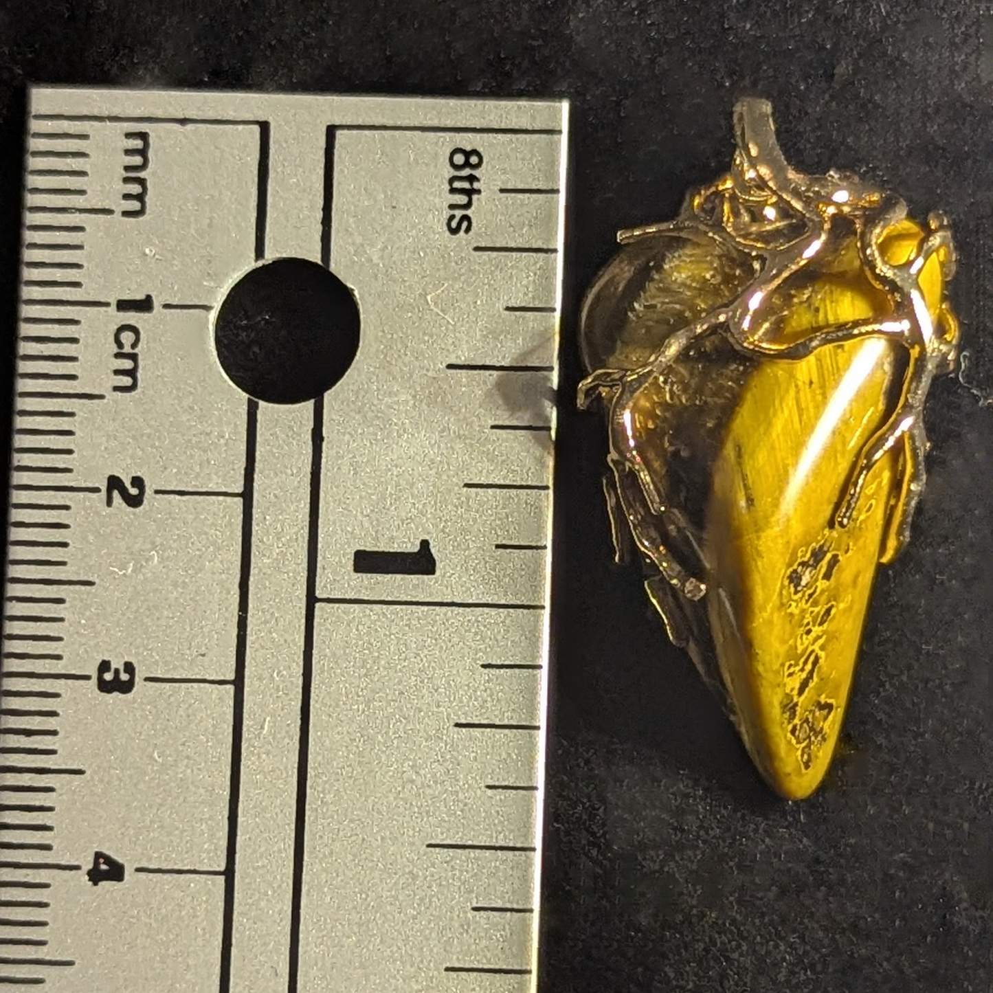 Wire-wrapped pendant featuring polished tiger's eye stone