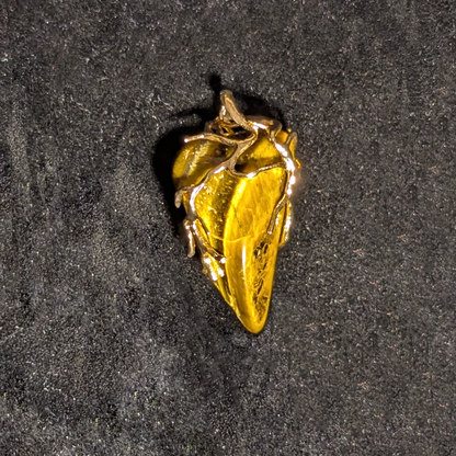 Wire-wrapped pendant featuring polished tiger's eye stone